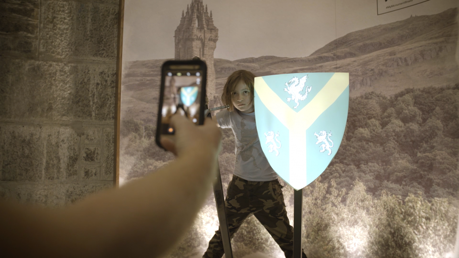 Design Your Shield
The Shield Interactive is a fun and engaging way for visitors to learn about shield design and heraldry. Visitors design their own shield, choosing divisions, colours, and charges before uploading their shield to a large projection mapped display wall.

Their design is also projected onto a shield canvas where they can pose for a photograph, leaving them with a memento from their visit to the monument.